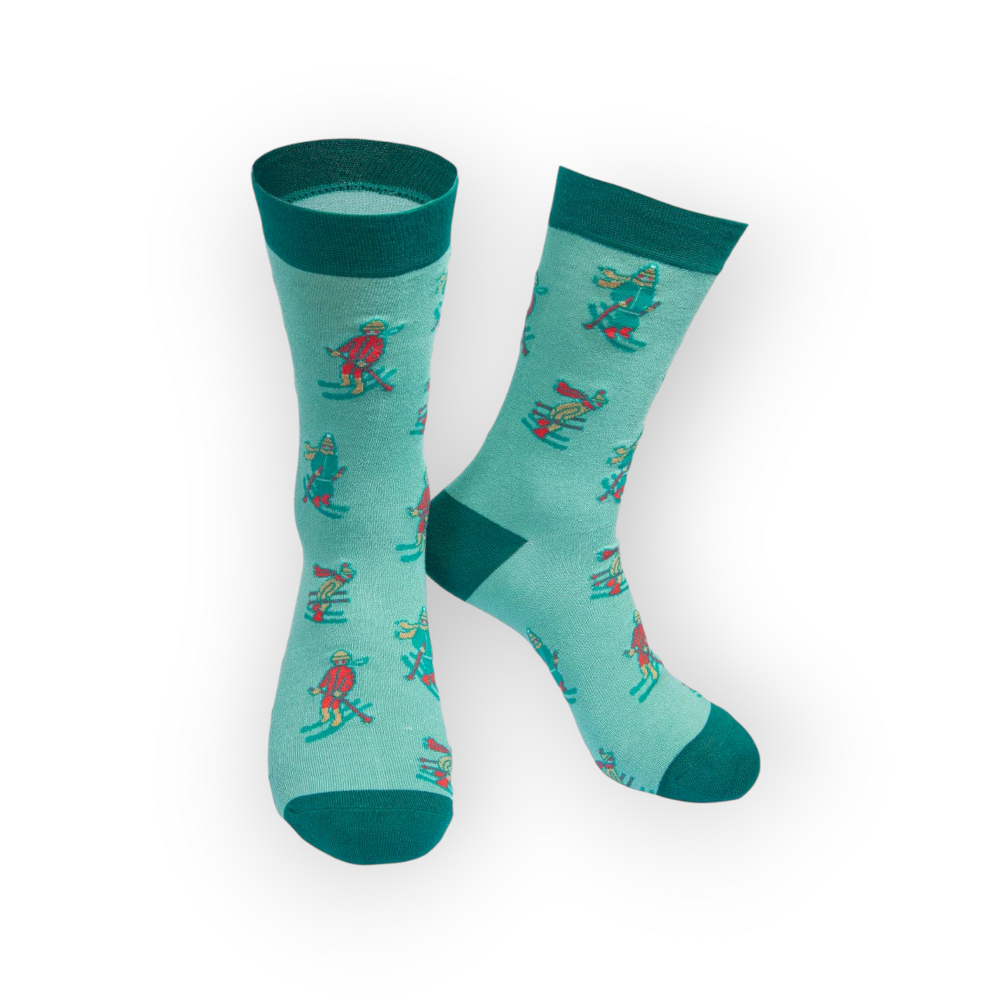 Two teal crew socks with a pattern of cartoon skiers in red, yellow, and blue. The skiers are wearing hats and scarves and are holding ski poles.