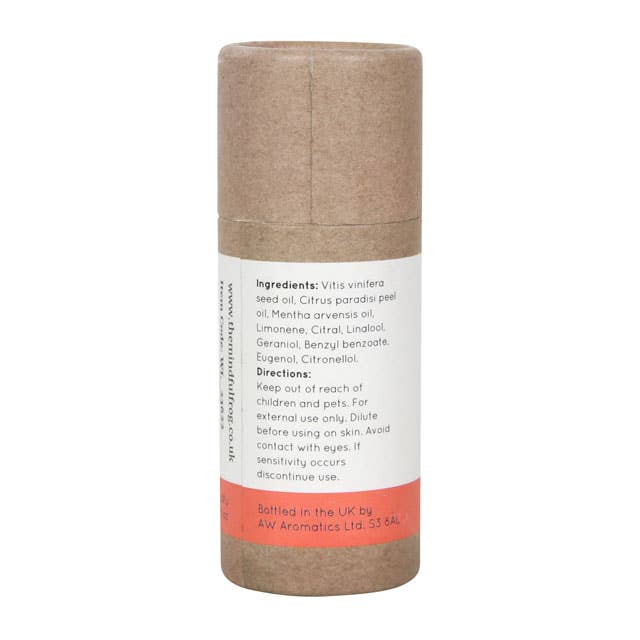 The back of a brown cardboard tube containing the "Confidence Boost" essential oil blend by The Mindful Frog. The label lists the ingredients, including Grape Seed Oil, Grapefruit Peel Oil, and Peppermint Oil. It also includes usage instructions and a warning to keep out of reach of children and pets.