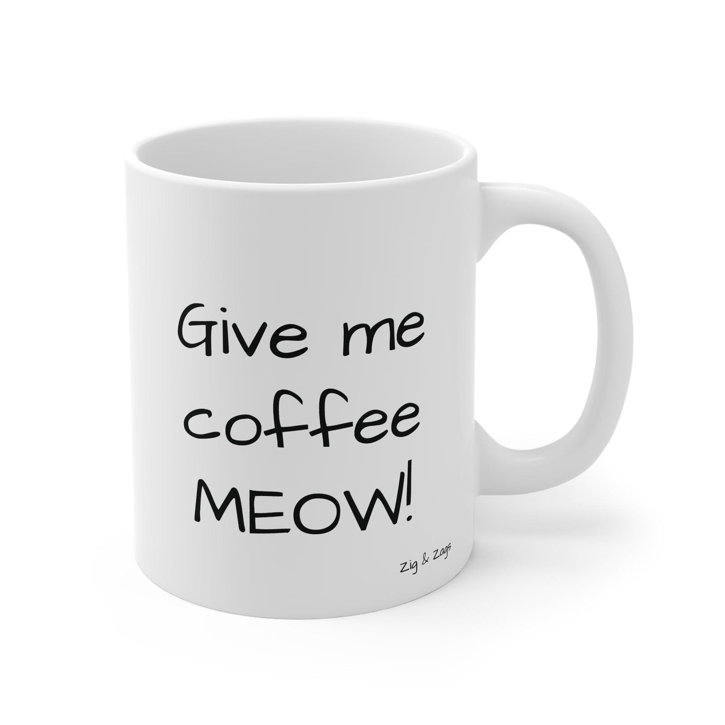 White ceramic coffee mug with black cat illustration and Give Me Coffee Meow text