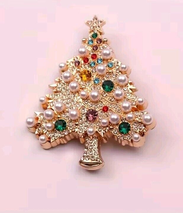 A gold-tone Christmas tree brooch adorned with colourful rhinestones and pearls.