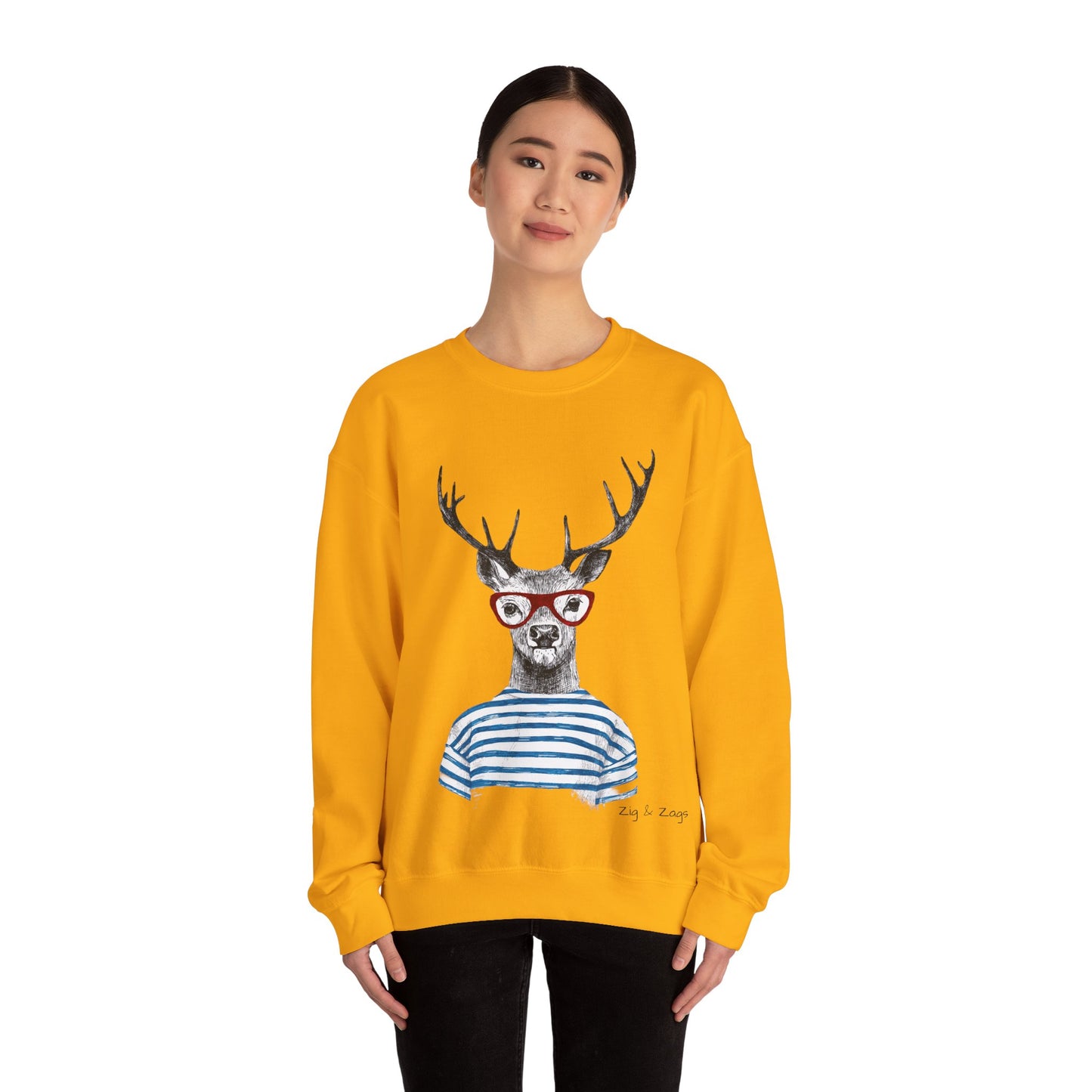 Person wearing a yellow sweatshirt with a deer graphic wearing glasses and a striped shirt on a white background